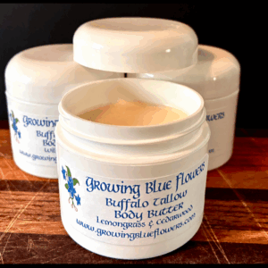 Picture of our Body Butter with the lid off showing the creamy looking body butter inside the jar.